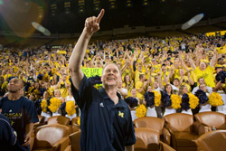 University of Michigan basketball coach John Beilein cheers at Crisler Arena when his team is chosen for the 2009 NCAA basketball tournament