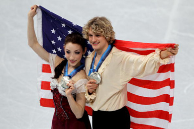 Charlie White and Meryl Davis hold up silver medals and an American flag