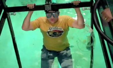 Anthony Reale dives into the water at U-M's hydrodynamics lab to tweak the Strait Power turbine.