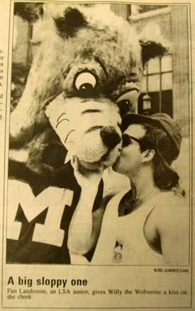 Michigan Daily photograph of Willy the Wolverine goofing around with a Michigan student