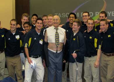 Loken was a father figure to hundreds, and his smile and playfulness were legendary--as when he revealed a torn shirt for this 2009 photo with the gymnastics team. (Photo: Colt Rosensweig