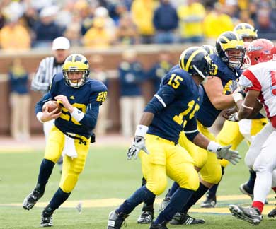 This run, a six yard dash during garbage time, was Jack Kennedy's career highlight so far. But the QB, like all walk-ons, plays an essential role behind the scenes for the team. (Photo: Martin Vloet, U-M Photo Services.) 