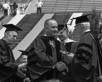 U-M President Harlan Hatcher confers an honorary degree to President Lyndon Baines Johnson during commencement 1964. (Image courtesy of U-M Bentley Historical Library.)