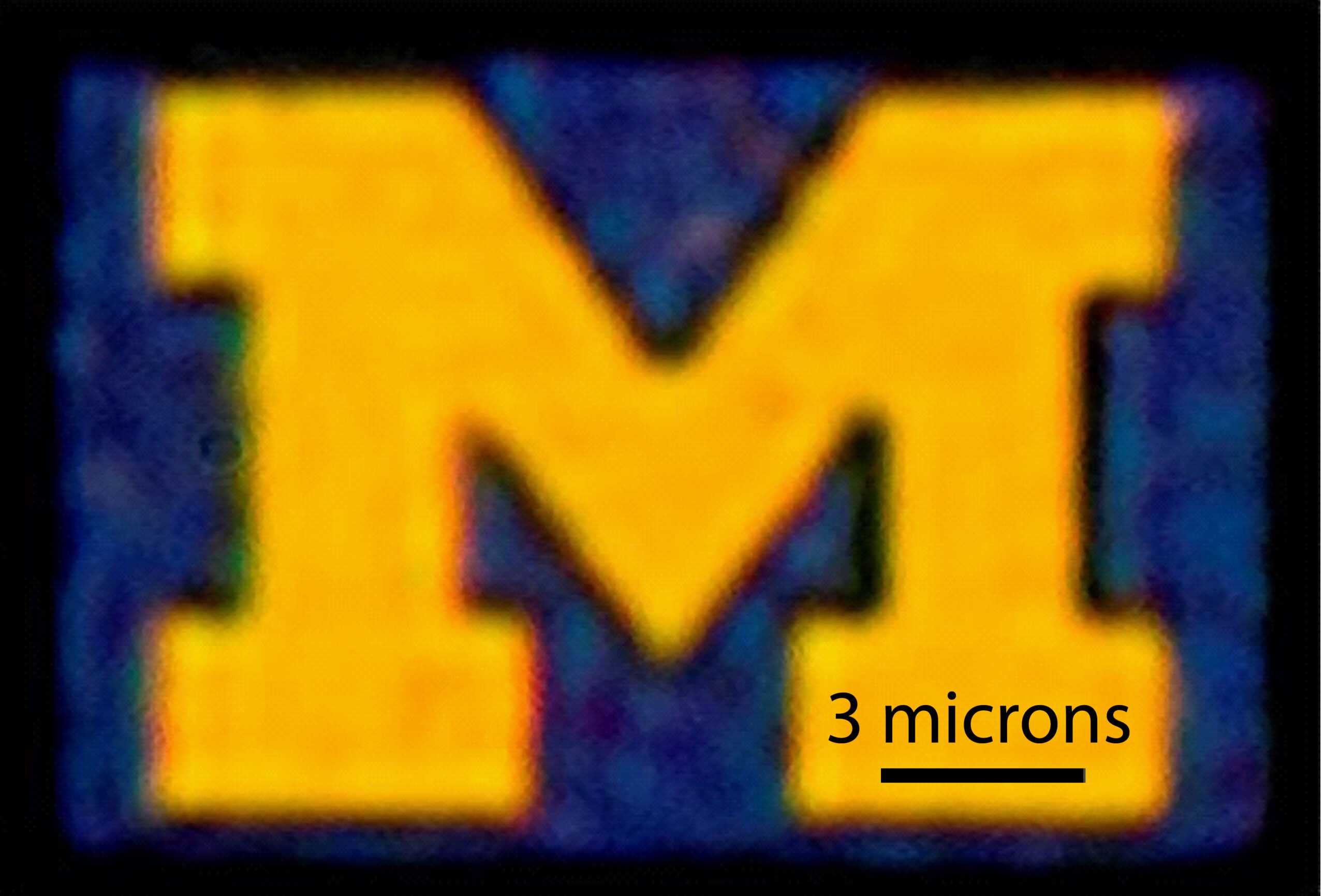 An optical microscopy image of a 12-by-9-micron U-M logo produced with this new color filter process. Credit: Jay Guo