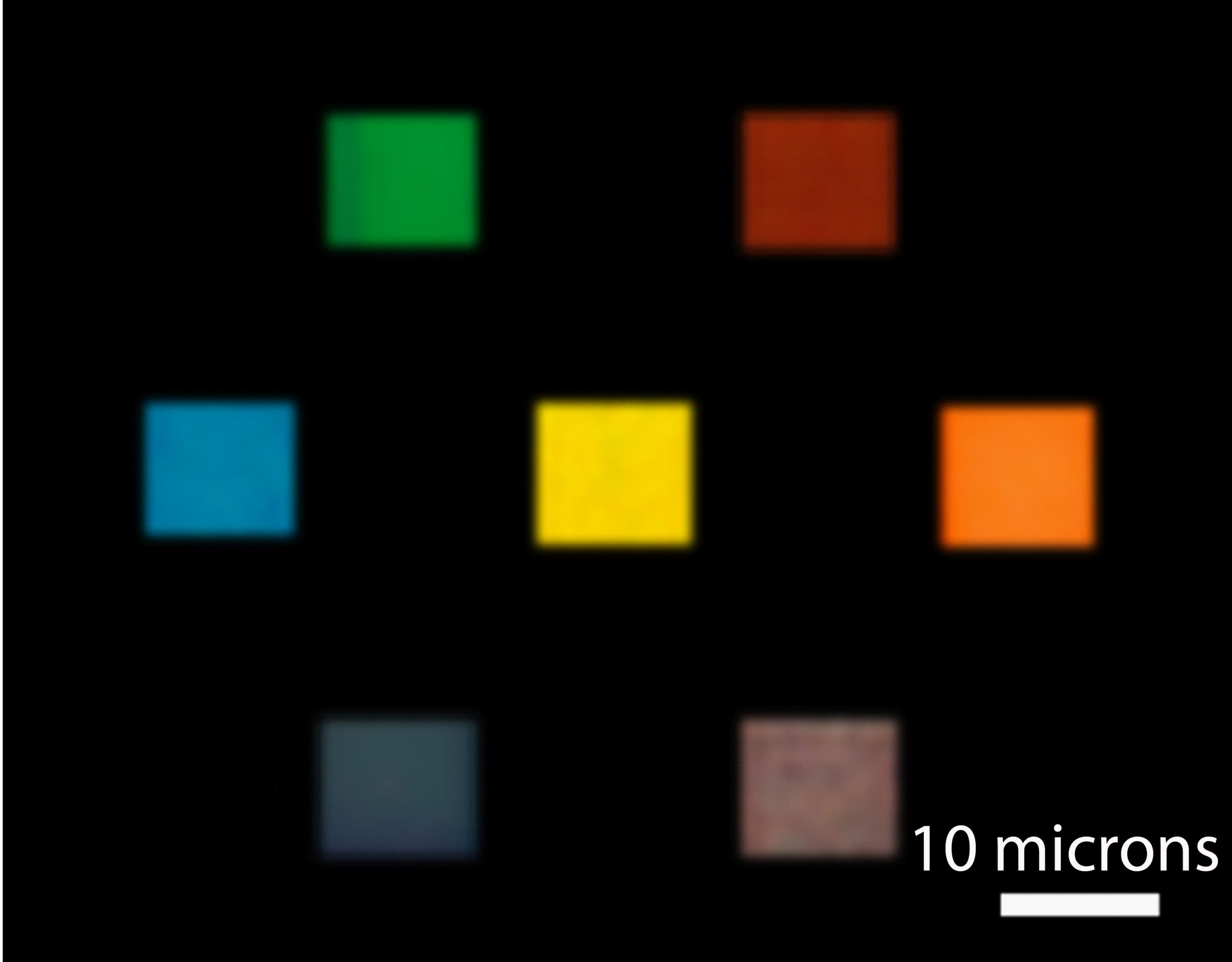 An optical microscopy image of seven color filters illuminated by white microscope light. Credit: Jay Guo