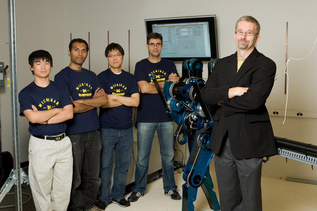 Jerry W. and Carol L. Levin Professor of Engineering Jessy Grizzle with MABEL and members of the Control Systems Lab. Credit: Martin Vloet, U-M Photo Services