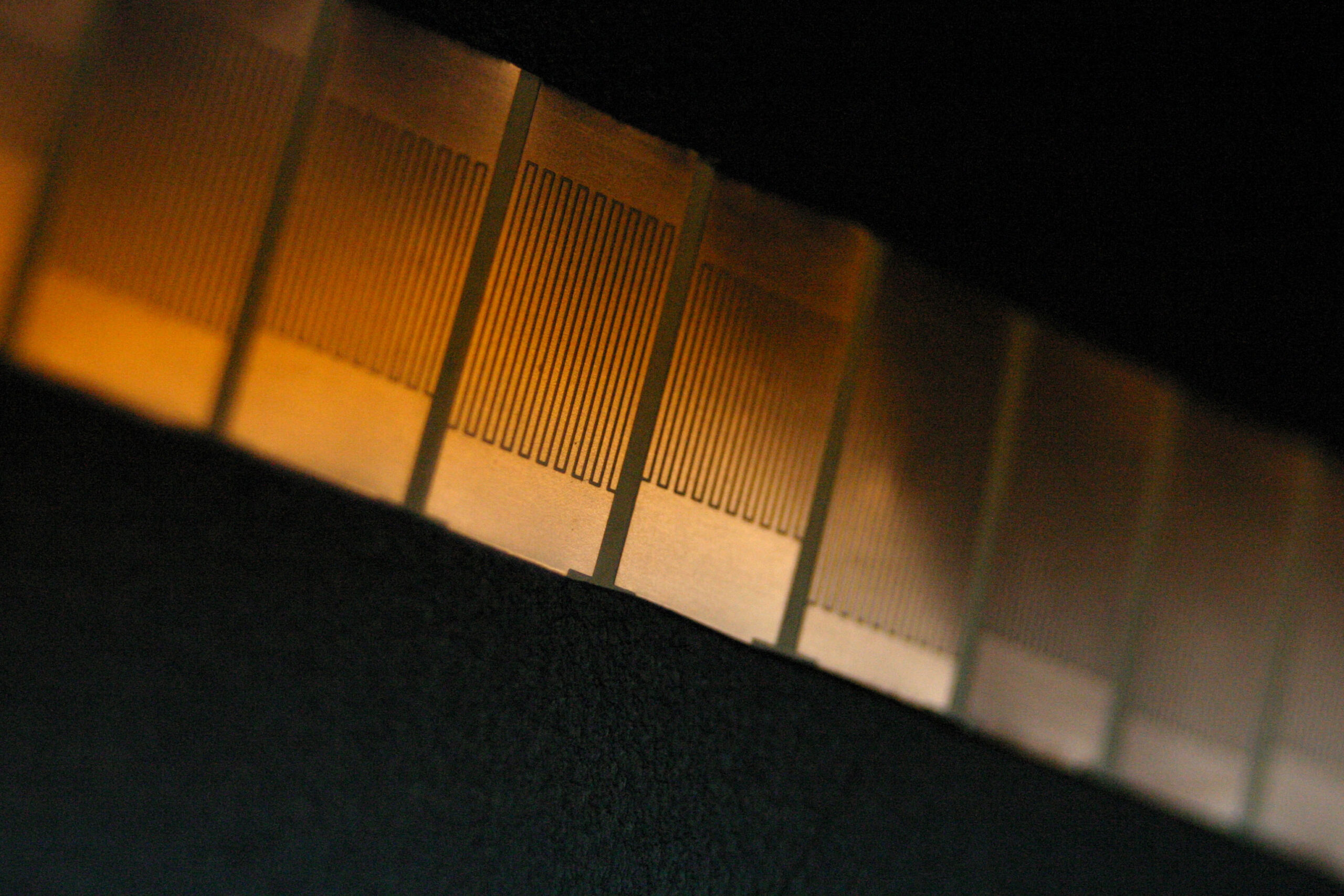Metamaterials such as this one developed by associate professor Anthony Grbic (EECS) can focus light to specks smaller than their wavelength. Similar materials are being developed at the new Center for Photonic and Multiscale Nanomaterials. They have applications in wireless power transfer, high resolution microscopes, and even, potentially, invisibility cloaks. Credit: Cyan James