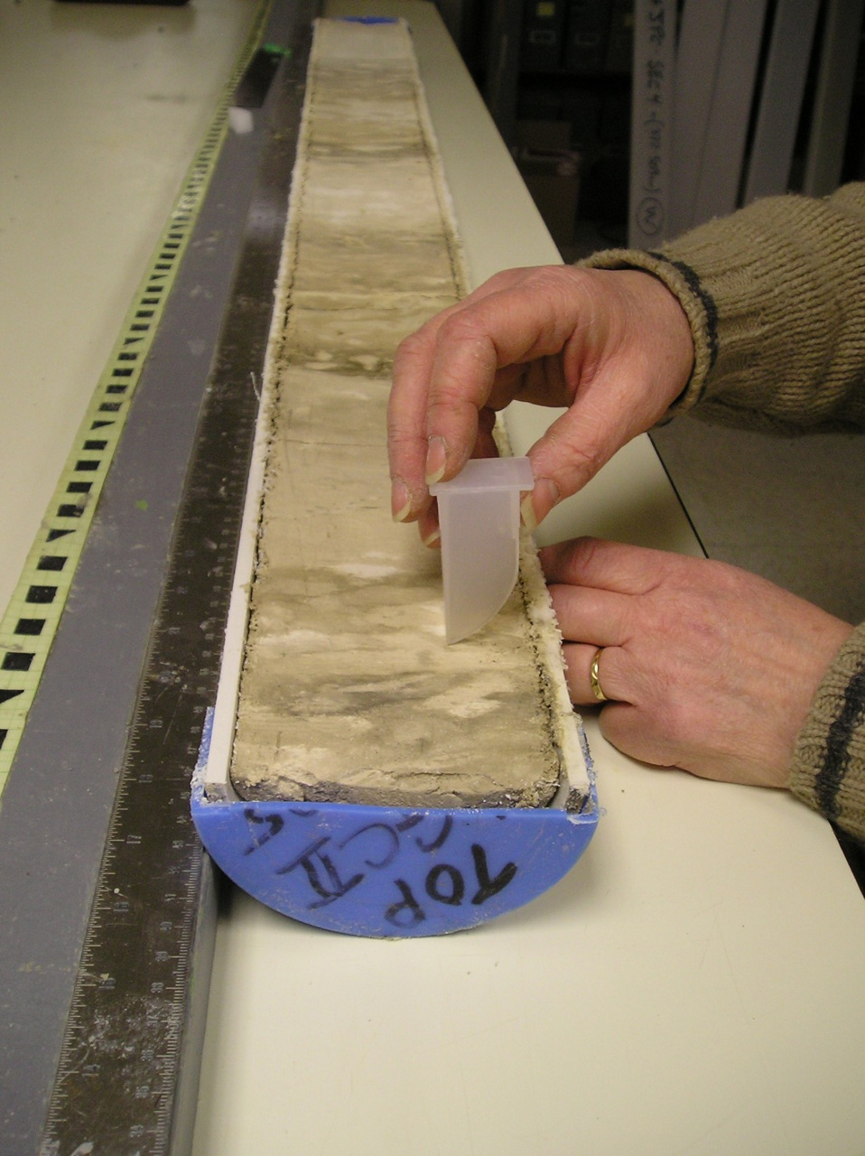 Scientists sampling a deep-sea sediment core. Credit: Alan Mix