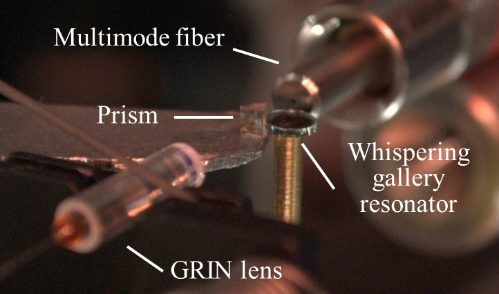 In the setup for this experiment, a telecommunication-compatible infrared beam is coupled to the whispering-gallery resonator through a diamond prism and the generated near-infrared, visible, and ultraviolet light are collected by a multi-mode fiber. Photo courtesy of Mona Jarrahi
