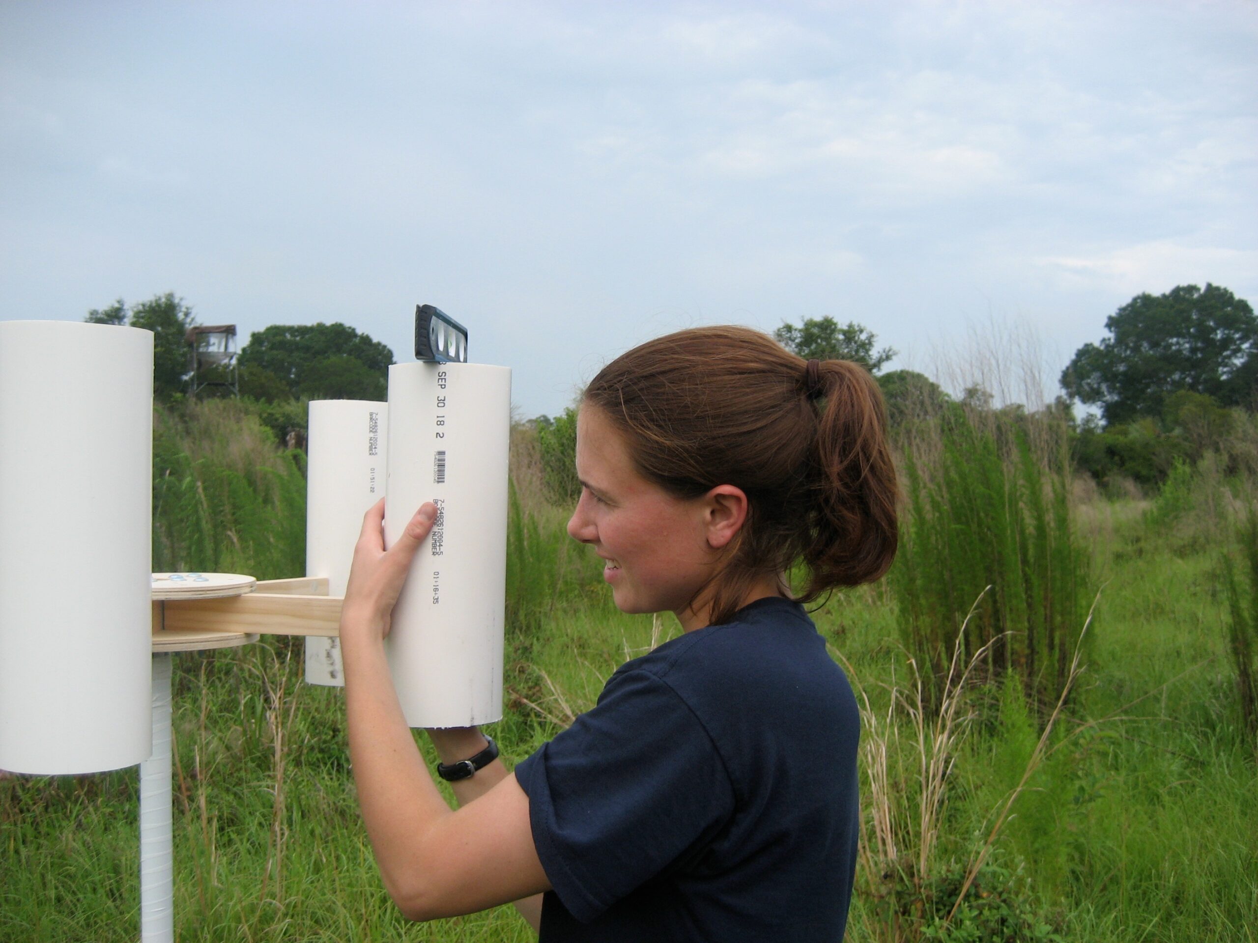 Laura Sherman setting up a sampling tripod to collect precipitation at one of the study sites near Crystal River, Florida. Photo courtesy of Emily White