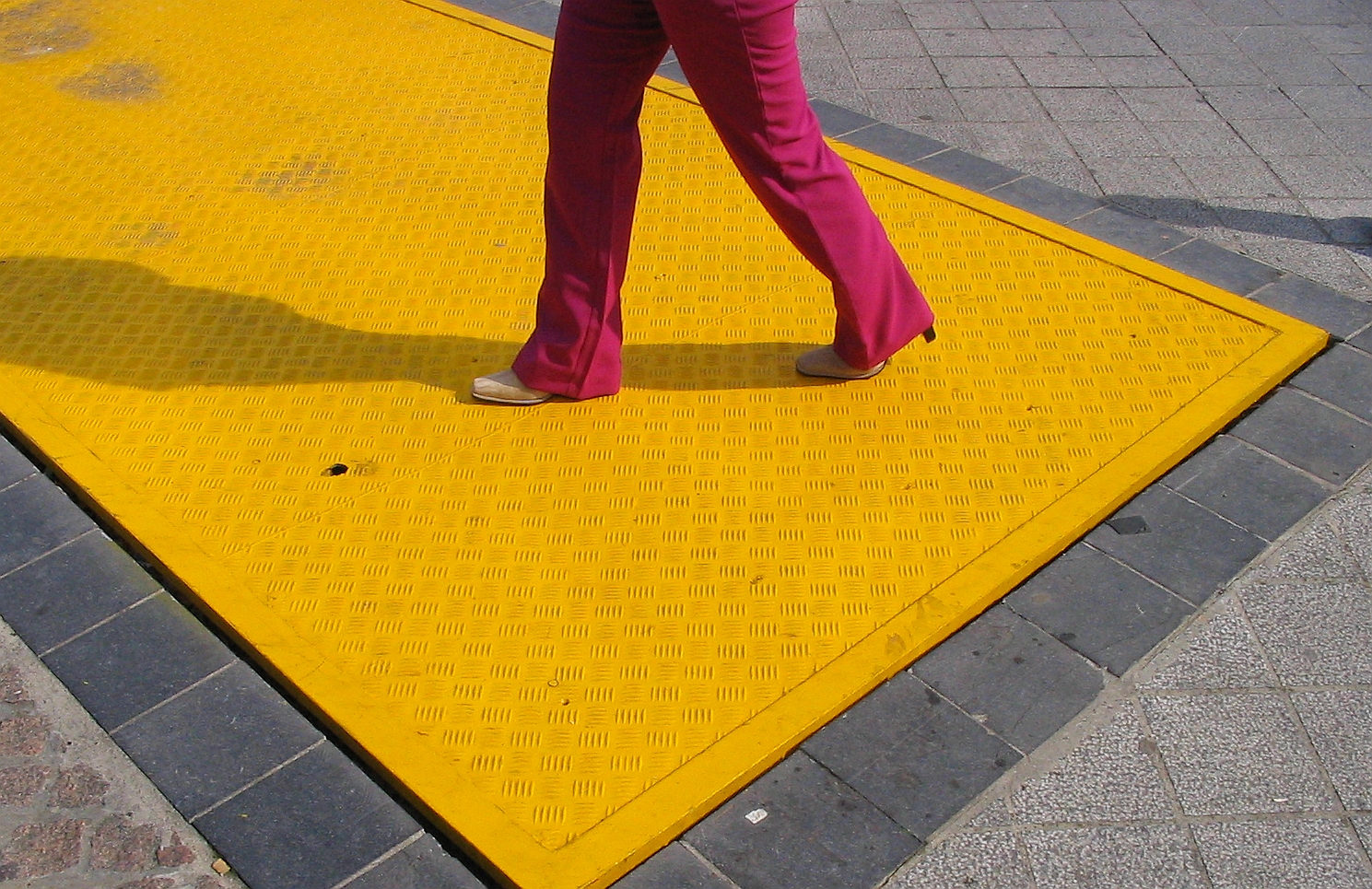 Pink-clad pants walking over bright yellow access panel. Image courtesy of sxc.hu user pixelbox