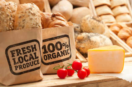 Image depicting breads in bags marked "Fresh Local Produce" and "100% Organic"