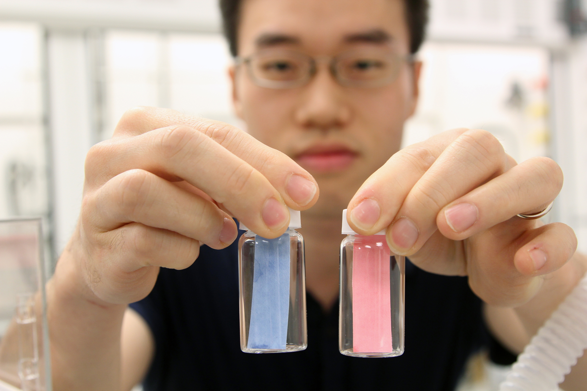 Sungbaek Seo, a doctoral student in the program in Macromolecular Science and Engineering holds paper litmus tests of Nerve Agent Detection at the NCRC building on UM North Campus. Tuesday, March 7th, 2012. Image credit: Marcin Szczepanski/University of Michigan, COE Multimedia Producer