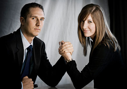 Image depicting a man and woman arm wrestling