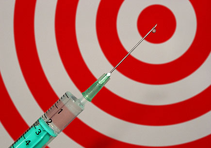 Photo of a syringe and bullseye (stock image)