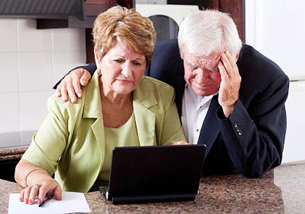 Unhappy senior couple looking worried (stock image)