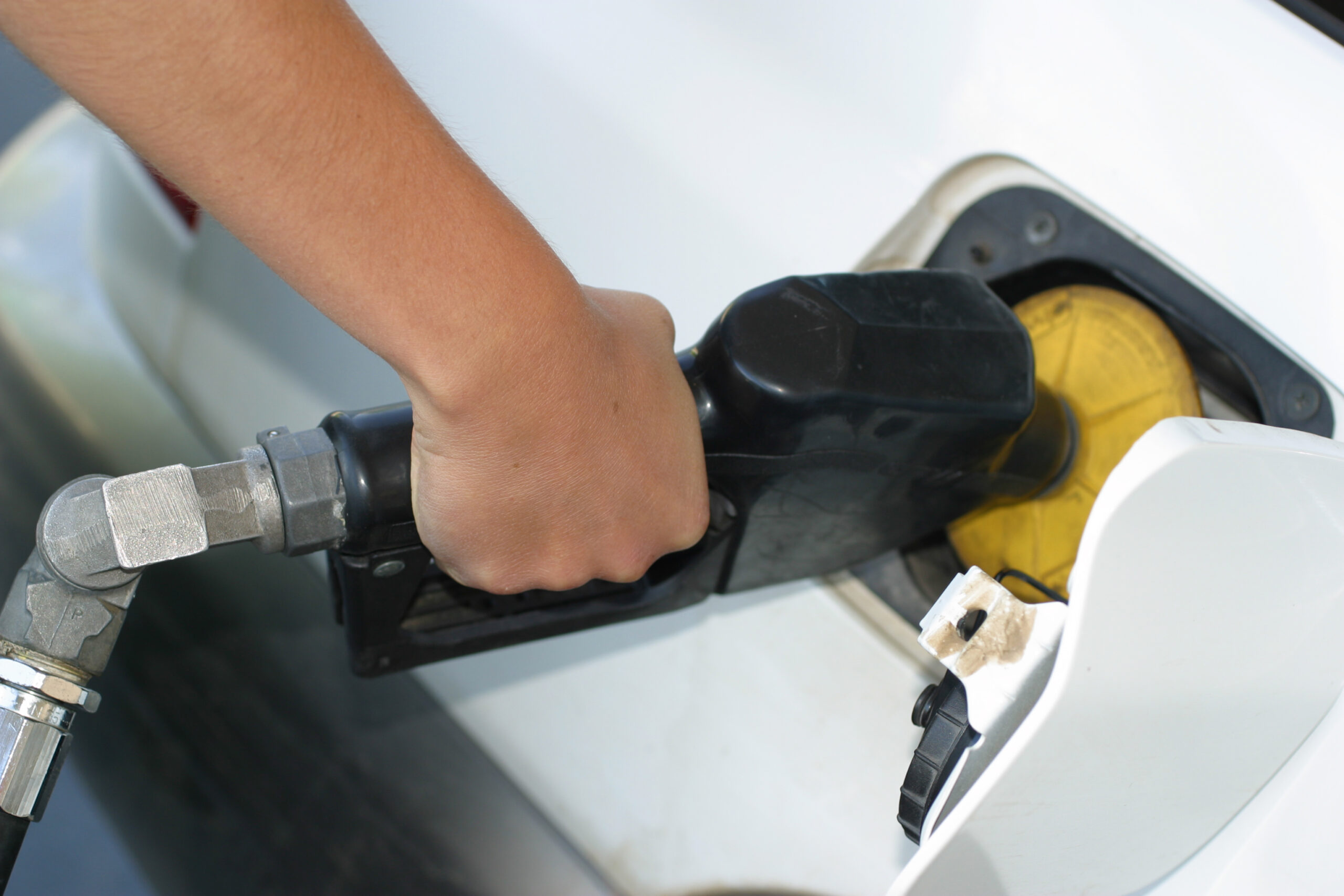 Photo of a hand holding a gas pump handle and filling up the car's tank. Image credit: sxc.hu user Egilshay 