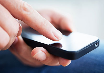 Close-up shot of hands of a businessman using a smartphone. (stock image)
