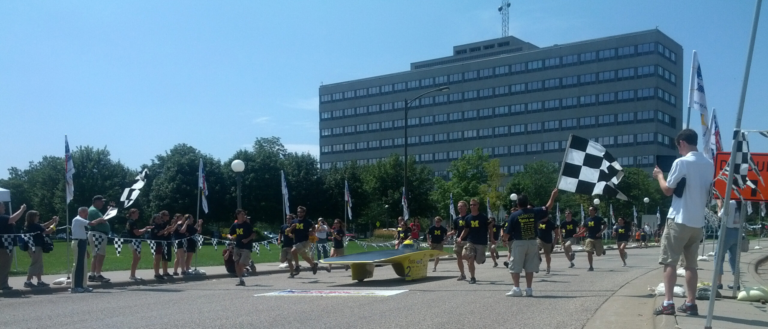 The University of Michigan Solar Car Team, with its car Quantum, crosses the finish line at 2:30pm on July 21, 2012 at the American Solar Car Challenge in St Paul, Minn.. The team won its fourth consecutive national championship with this event (and 7th overall), and broke the national record, winning by 10 hours and 18 minutes over its nearest competitor. Image credit: Ethan Lardner, U-M Solar Car Team