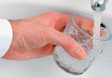 Photo of a hand filling a glass with tap water. Image credit: sxc.hu user ArtMast