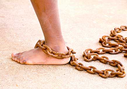 Photo of a small dirty lef with a chain around the ankle (stock image)
