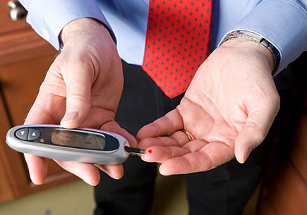 A businessman checks his blood glucose level. (stock image)
