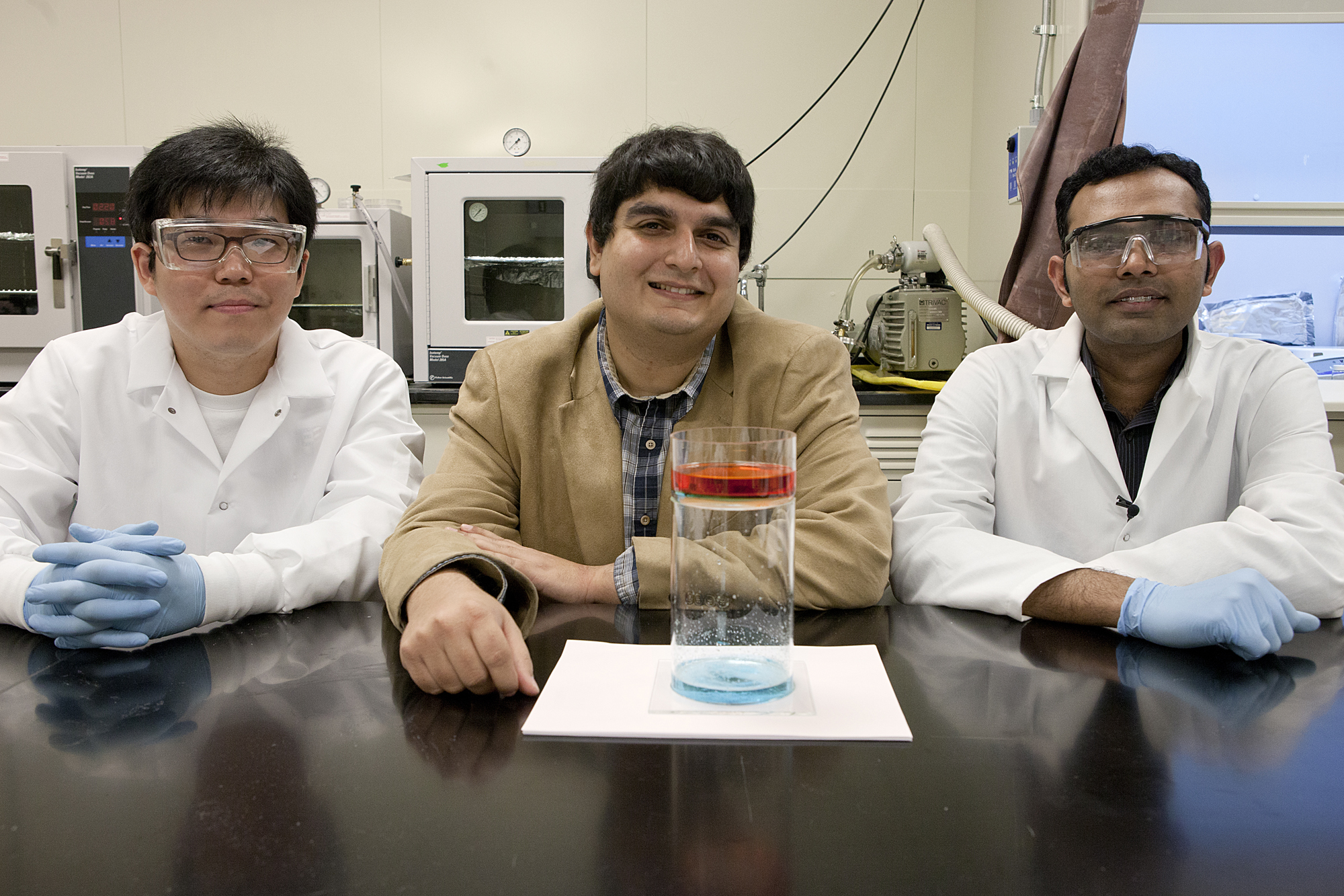  Doctoral student Gibum Kwon, postdoctoral researcher Arun Kota and assistant professor Anish Tuteja, all in in materials science and engineering, have developed a filter coating that can separate oil and water with gravity alone and lead to more energy-efficient oil spill clean-up, among other applications. Photo by Laura Rudich