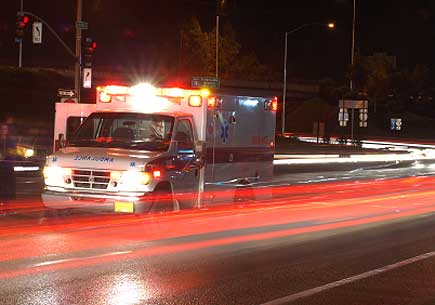 A ambulance at the scene of a motor vehicle accident during the early winter evening. (stock image)