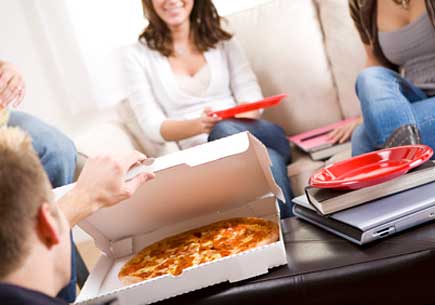 Group of students taking a study break for pizza. (stock image)