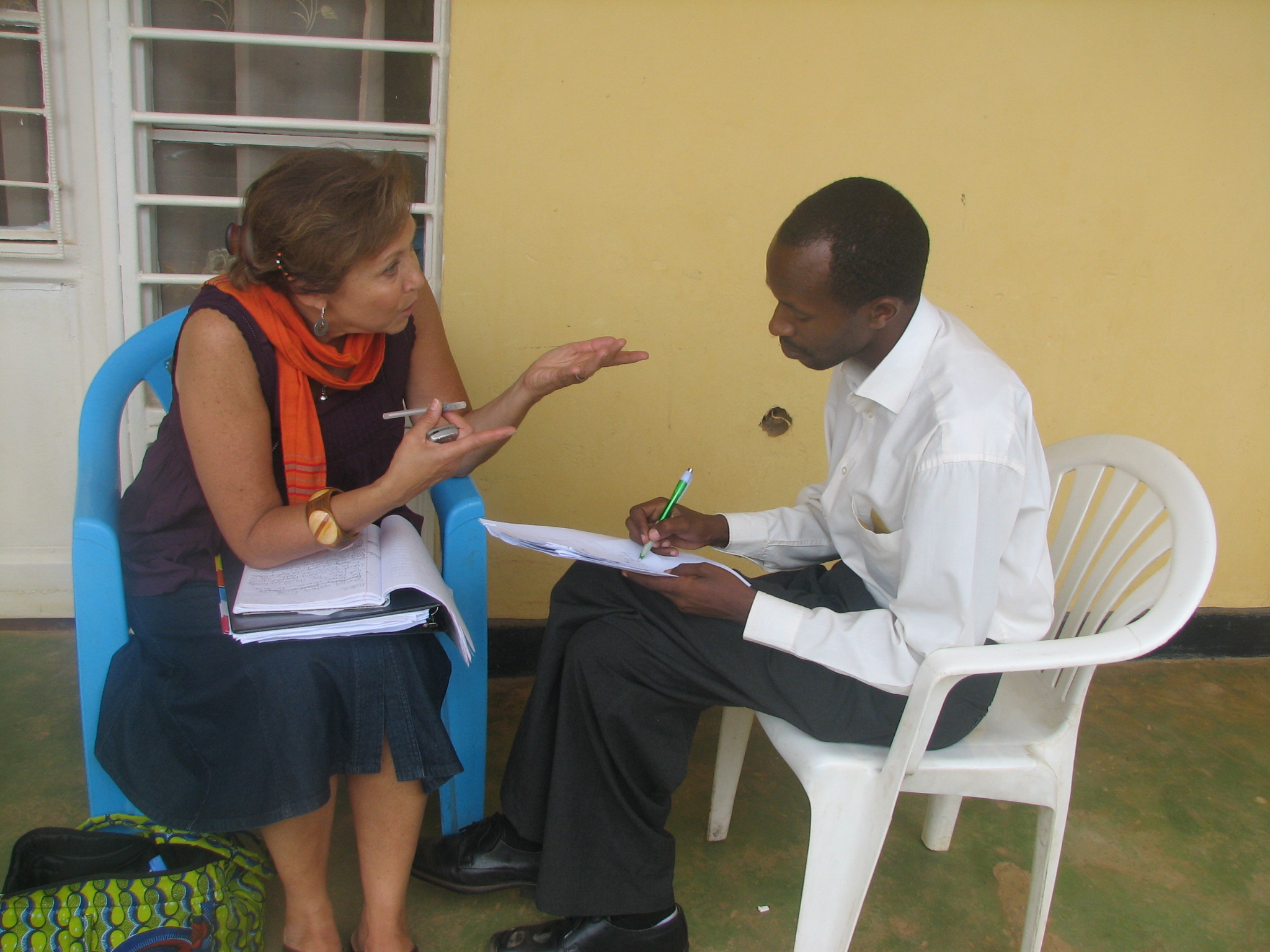 Patricia Pasick, founder of Stories for Hope talks about the project with Kanamugire Theophile, director of a local NGO in Nyamata, Rwanda. Photo courtesy of Patricia Pasick
