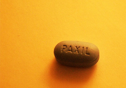 Image of a pill tablet on a yellow background. Image credit: flickr.com user ~!