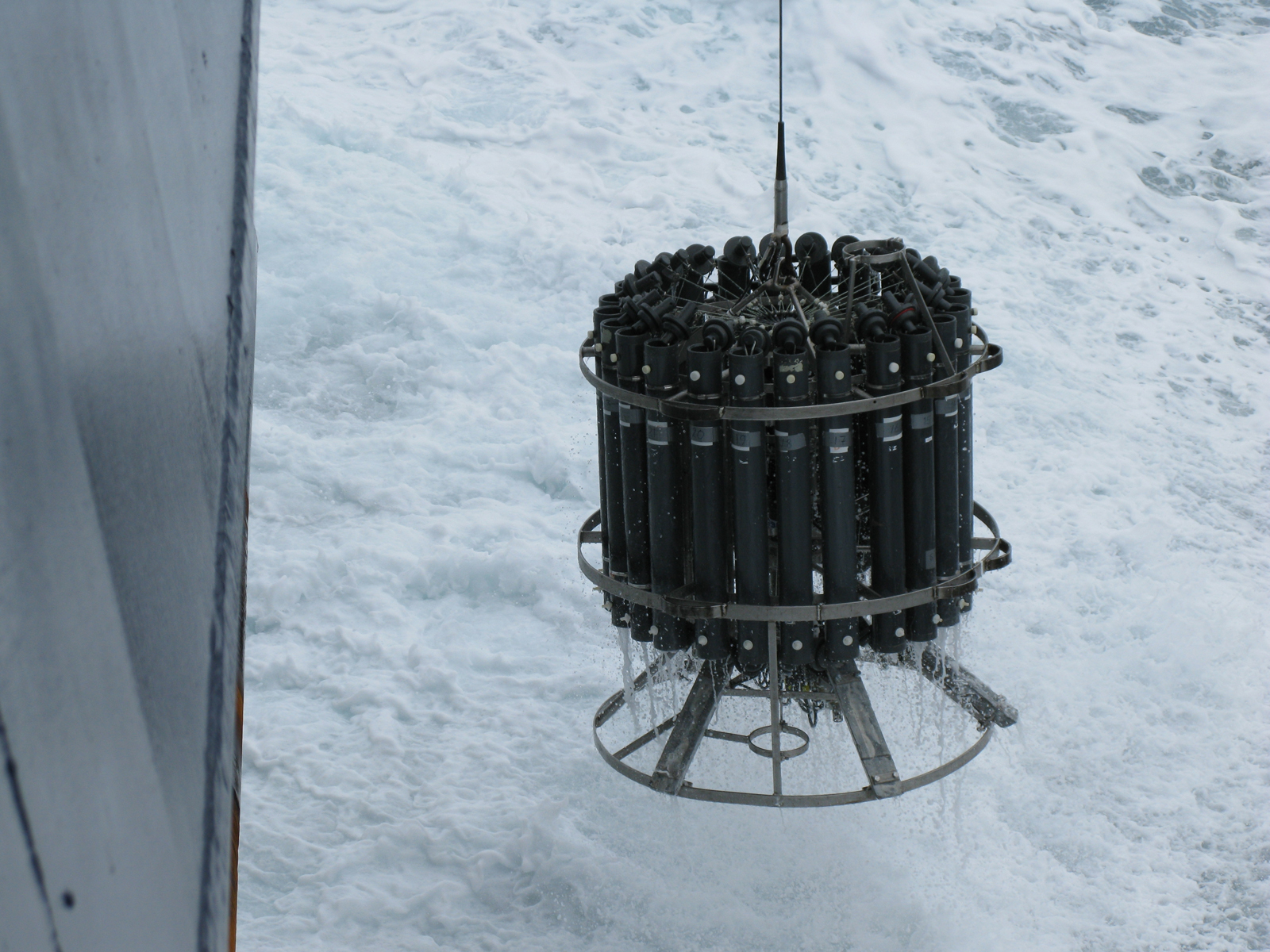 A sample-collecting device called a rosette is lowered into the ocean off the coast of Antarctica. Photo by Lollie Garay.