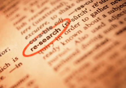 Text on a page with the definition for the word research circled in red (stock image)