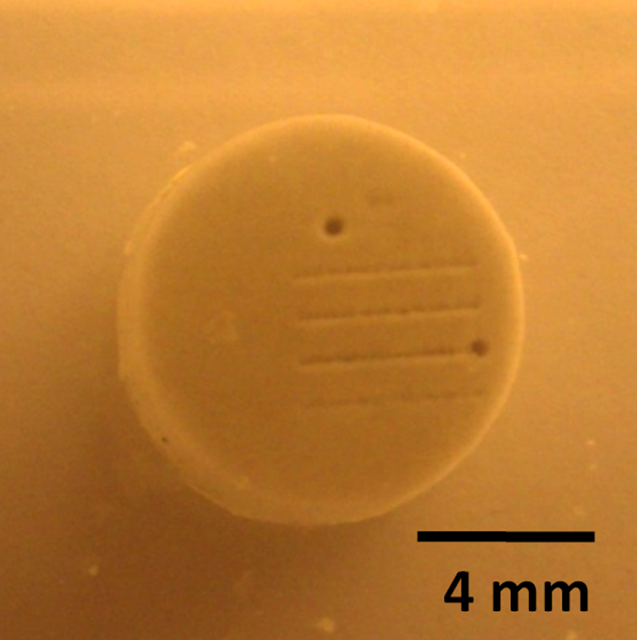 With a new technique that uses tightly-focused sound waves for micro-surgery, University of Michigan engineering researchers drilled a 150-micrometer hole in a confetti-sized artificial kidney stone. Image credit: Hyoung Won Baac