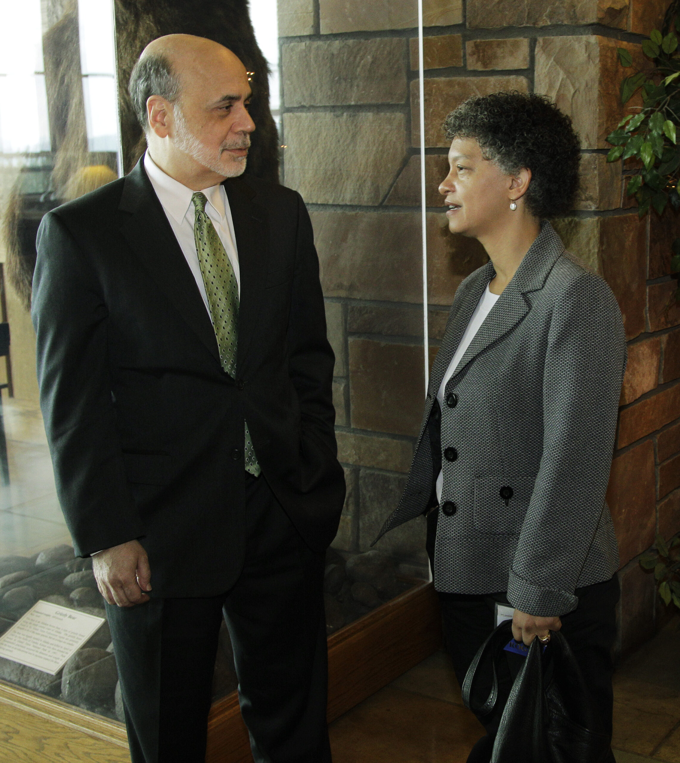   Federal Reserve Chairman Ben Bernanke, left, visits with Susan Collins, right, Dean of the Gerald R. Ford School of Public Policy at the University of Michigan, as they pose for photos during a break in the Jackson Hole Economic Symposium, Friday, Aug. 31, 2012, at Grand Teton National Park near Jackson Hole, Wyo. Image credit: Ted S. Warren, Associated Press