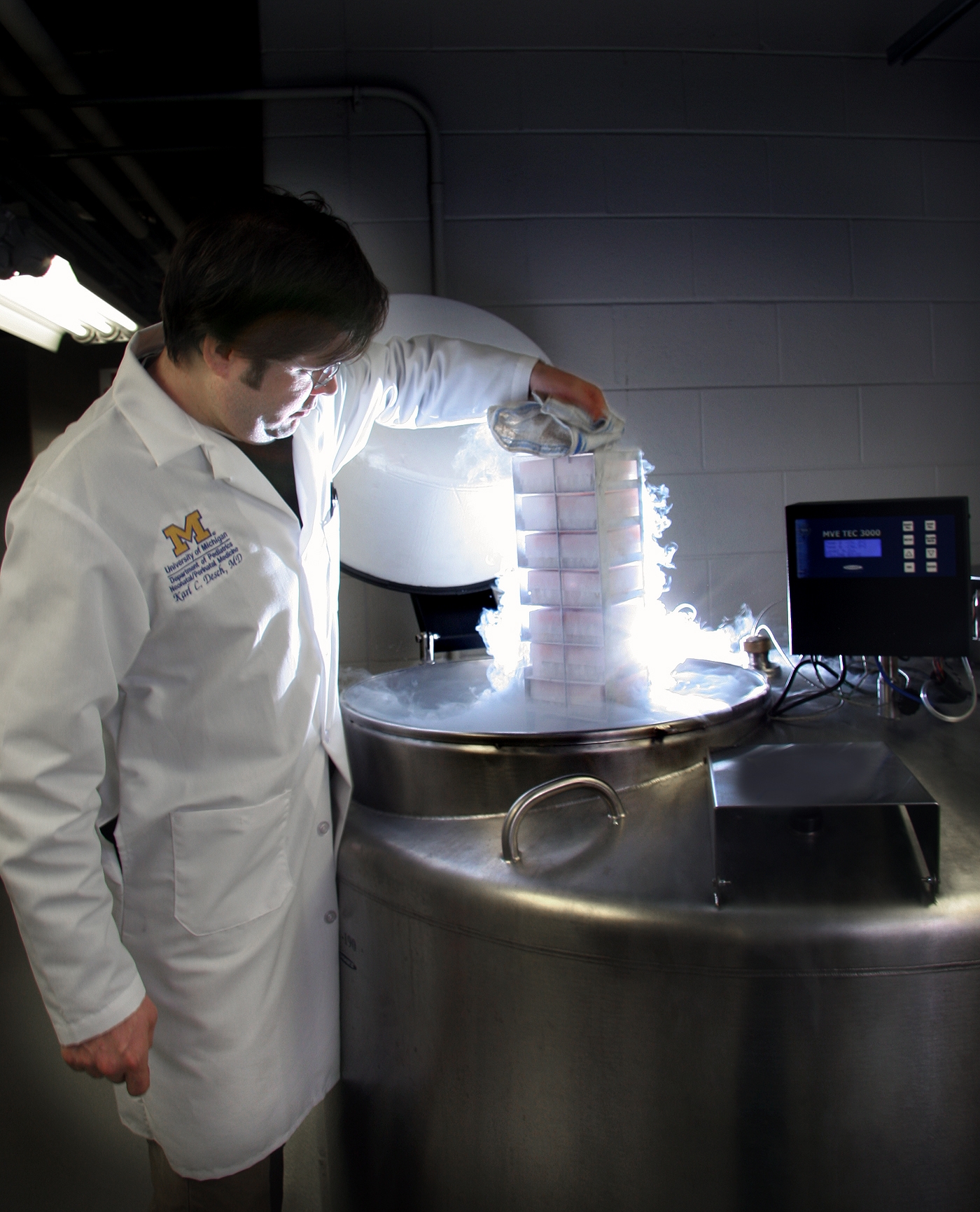 Dr. Karl Desch of the U-M Medical School removes blood samples from a liquid nitrogen storage tank. Image credit: Craig Breil