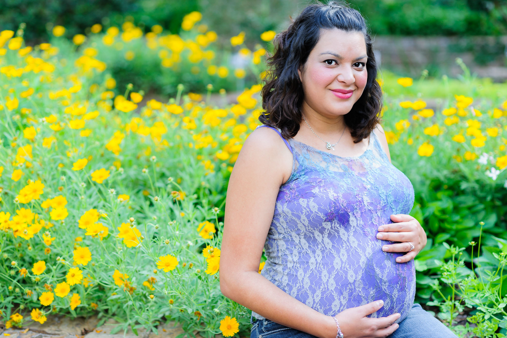Photo of a beautiful pregnant Hispanic woman in a garden. Image credit: flickr.com user dharrisphotog
