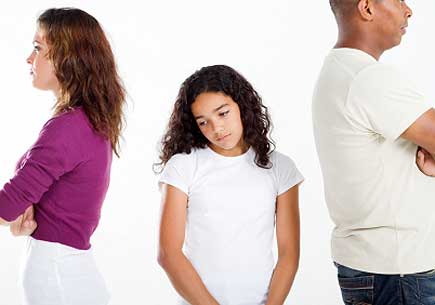 Unhappy girl standing between ather and mother. (stock image)