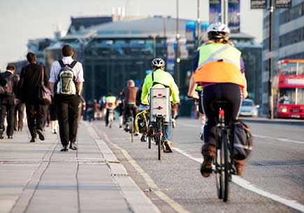 City workers walking and buses and taxi's driving over Waterloo Bridge at the end of the working day. (stock image)