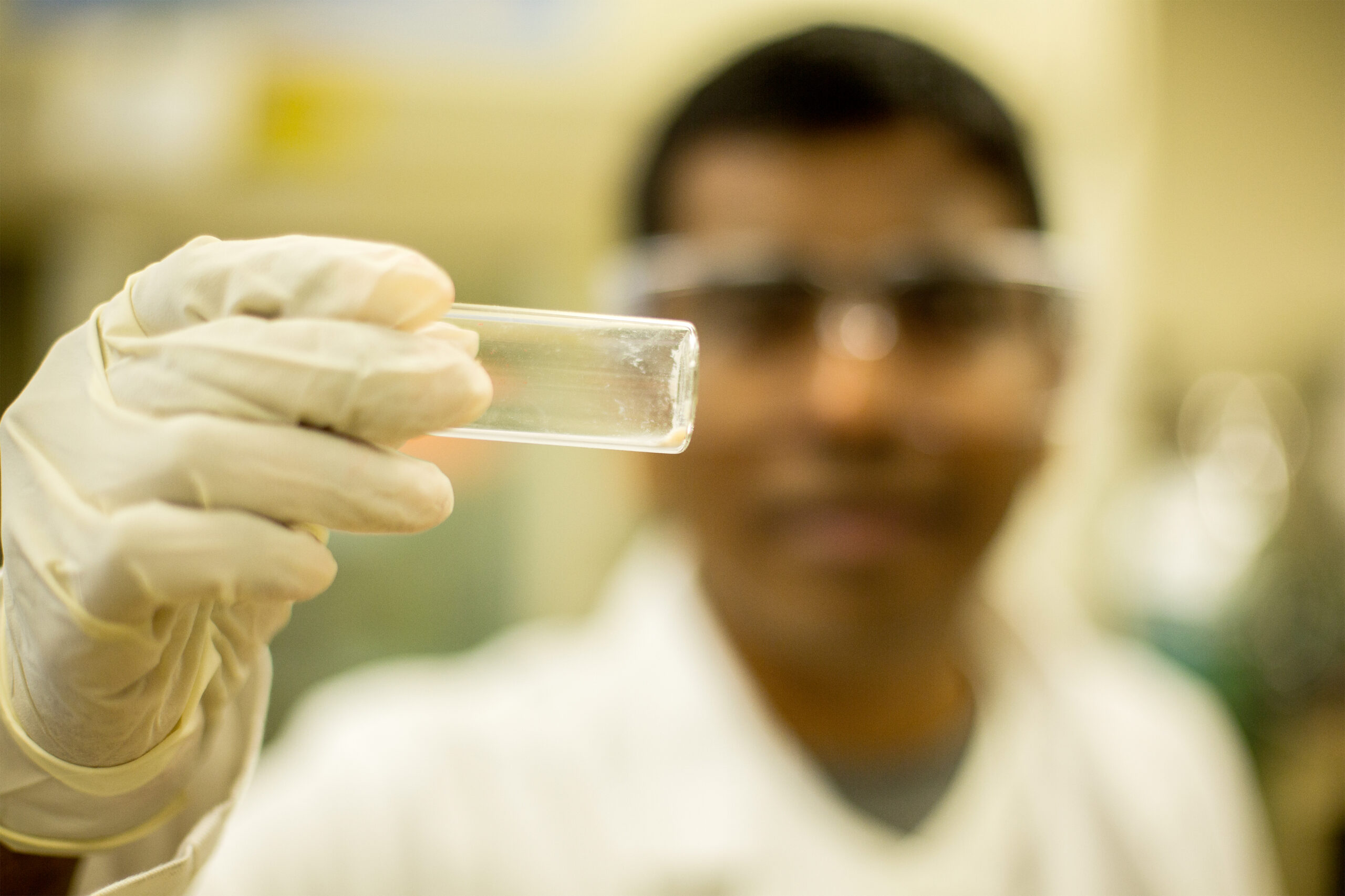 Marimuthu Andiappan, a PhD student in the Linic lab, holds up a small sample of the copper catalyst. The copper nanoparticles can use light to get rid of the oxygen bound to their surfaces, making it possible for copper to catalyze a chemical industry "holy grail" reaction. Photo: Joseph Xu, Michigan Engineering Communications & Marketing.
