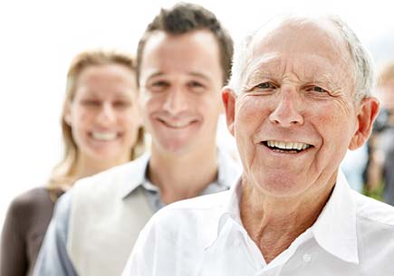 Closeup portrait of an old man smiling with his son and daughter in background. (stock image)