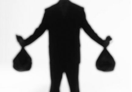 Silhouette of a man holding money bags. (stock image)