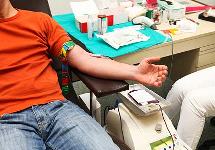 Man donating blood in a blood bank. (stock image)