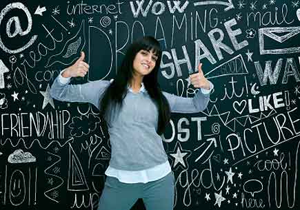 Young girl in front of a chalkboard covered with social network-related images and text. (stock image)