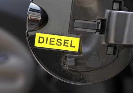 Close-up photo of the inside of a gas tank cover with a label saying "diesel". (stock image)