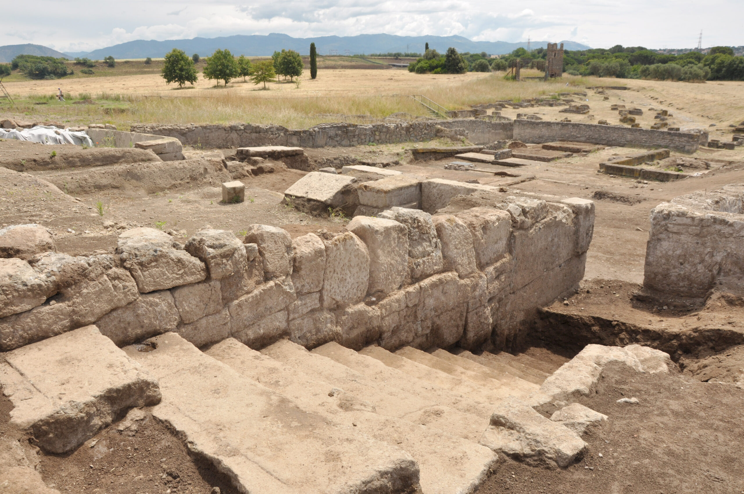 University of Michigan archeologists digging in Italy have unearthed a grand structure unlike anything the Romans were known to be building at the time. Dating back 300 years before the Coliseum, the football-field-sized monument contains two terraces connected by a grand staircase, a massive stone retaining wall and geometrically patterned floors. Images courtesy: Marcello Mogetta