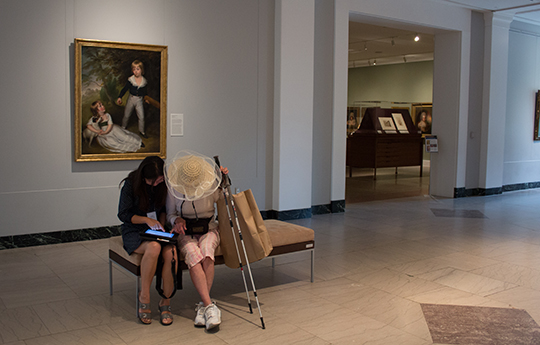 A UMMA visitor responds to a survey about her experience at the museum. The survey was designed and conducted by PSM students. Image credit: Eva Menezes/ISR.