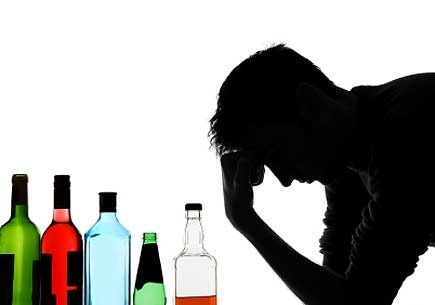 Silhouette portrait of a man with several glass bottles containing various liquids. (stock image)