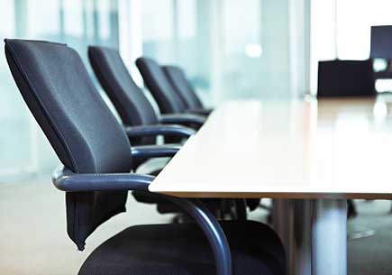 Empty chairs at the boardroom table. (stock image)