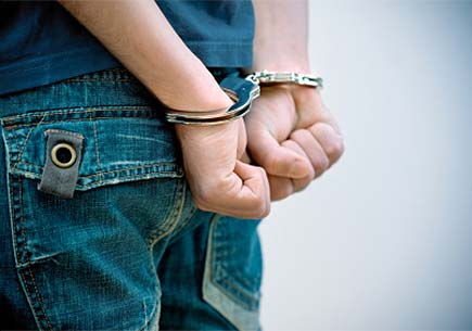 Young man in handcuffs